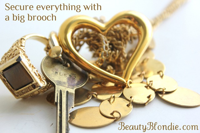Secure everything on your gold necklace with a big brooch at BeautyBlondie.com