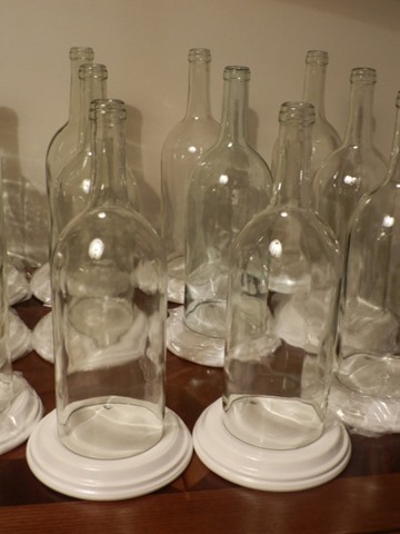 Clear Wine Bottles with a candle in the middle