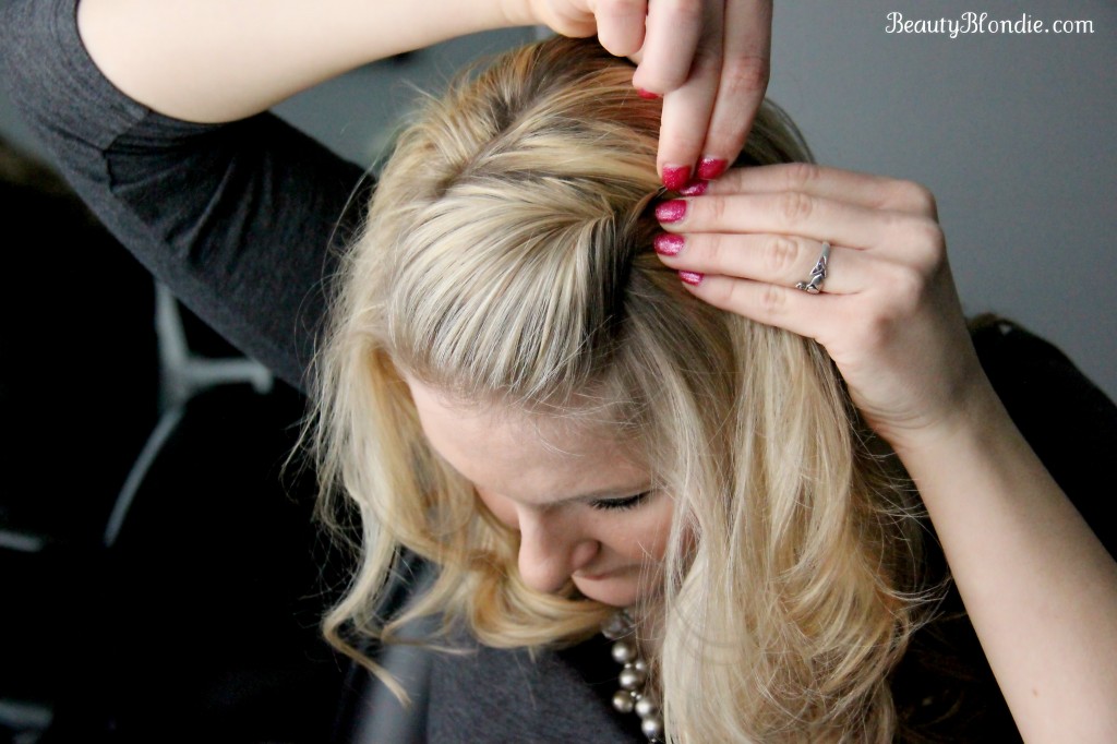 With the open end of the bobby pin facing the back of your head, grab a piece of hair and twist the bobby pin around so that the open end is facing the front of the head.