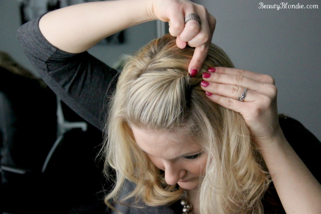 With the opened end of the bobby pin facing the front of the head and insert it into the poof.